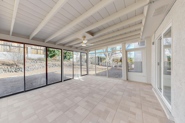 unfurnished sunroom with beamed ceiling, a ceiling fan, and visible vents