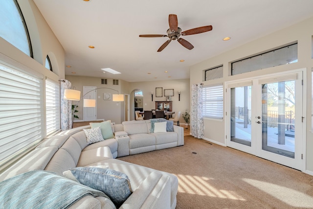 living room with arched walkways, recessed lighting, carpet flooring, visible vents, and baseboards