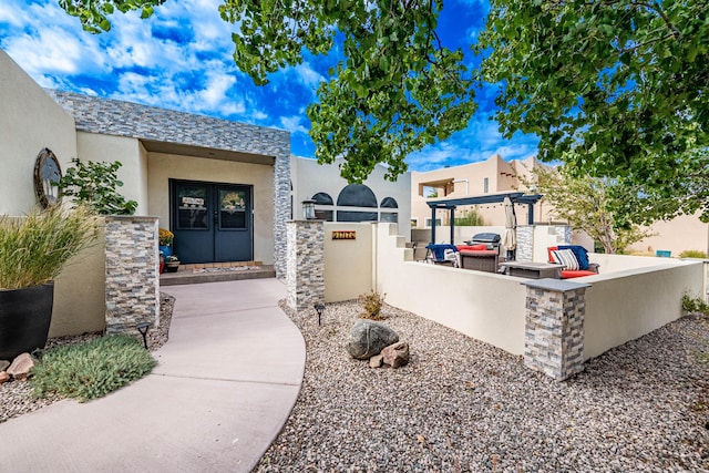 doorway to property with area for grilling and stucco siding