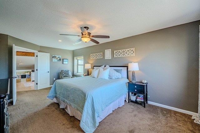 carpeted bedroom with ceiling fan, baseboards, and a textured ceiling