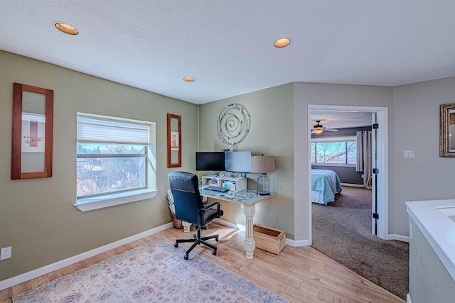 home office featuring a textured ceiling, recessed lighting, wood finished floors, and baseboards