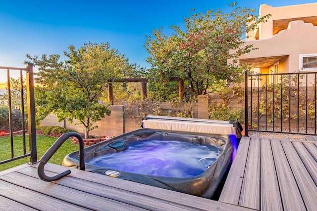 wooden deck featuring fence and hot tub deck surround