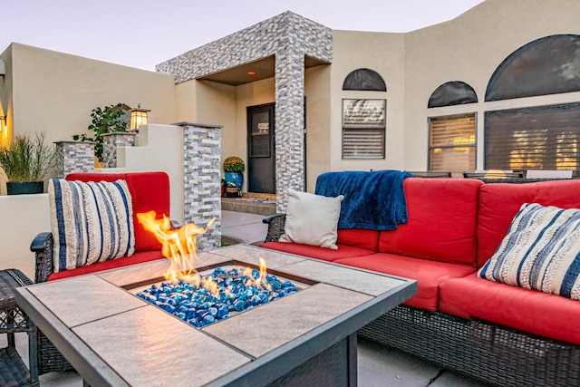 view of patio / terrace with an outdoor living space with a fire pit