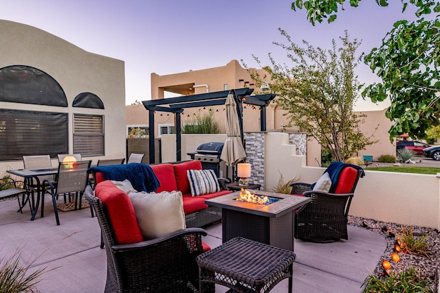 view of patio with outdoor dining space and an outdoor living space with a fire pit