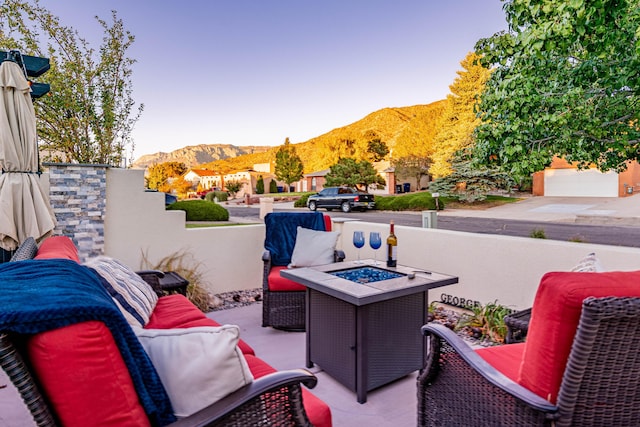 balcony with an outdoor living space with a fire pit and a mountain view