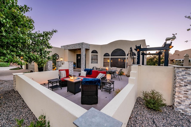 view of patio / terrace featuring an outdoor living space with a fire pit