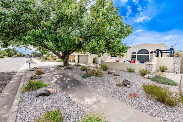 view of yard with an attached garage, driveway, and a fenced front yard