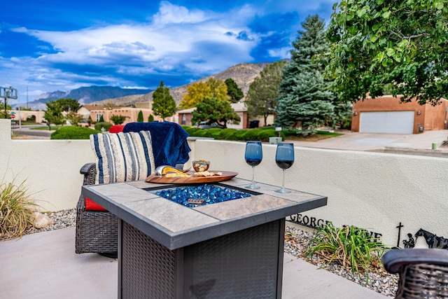 view of patio / terrace with an outdoor fire pit and a mountain view