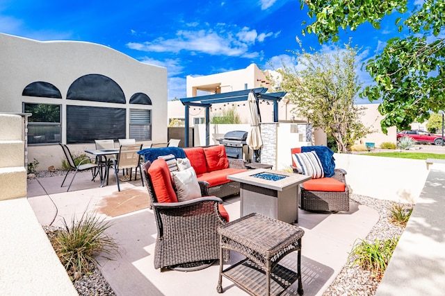 view of patio / terrace with exterior kitchen, outdoor dining area, grilling area, and an outdoor living space with a fire pit