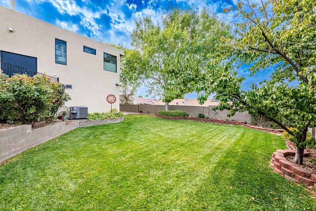 view of yard featuring fence and central AC unit