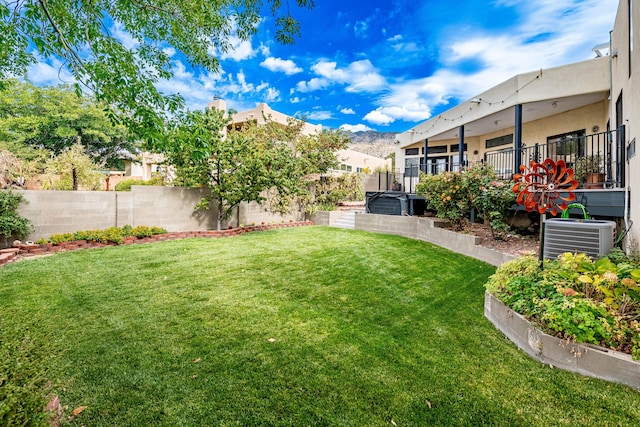 view of yard featuring a fenced backyard, a mountain view, and cooling unit