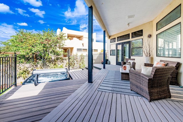 wooden terrace featuring outdoor lounge area, a covered hot tub, and visible vents