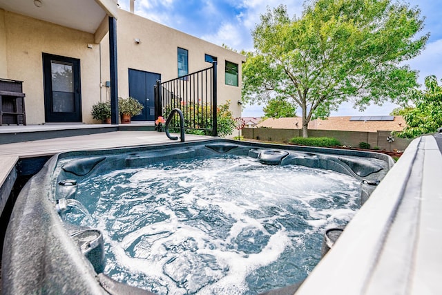 view of swimming pool with an outdoor hot tub