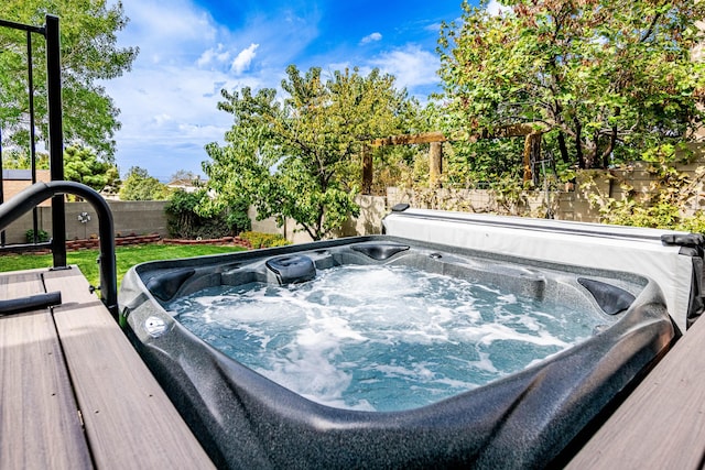 view of swimming pool with a covered hot tub and a fenced backyard