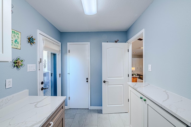 bathroom featuring a textured ceiling and vanity