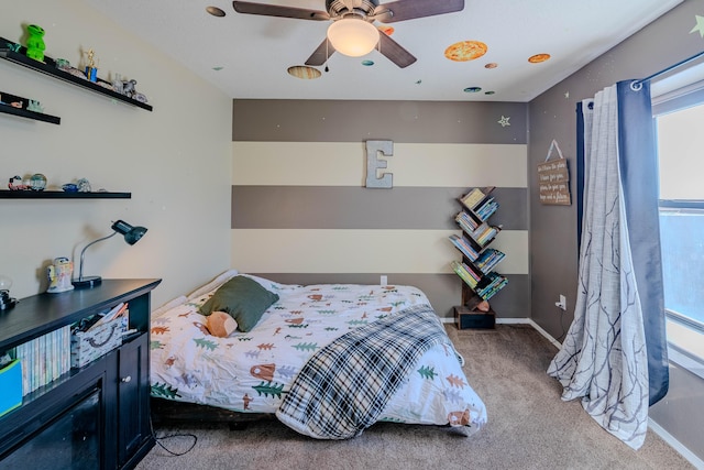 carpeted bedroom featuring ceiling fan and baseboards