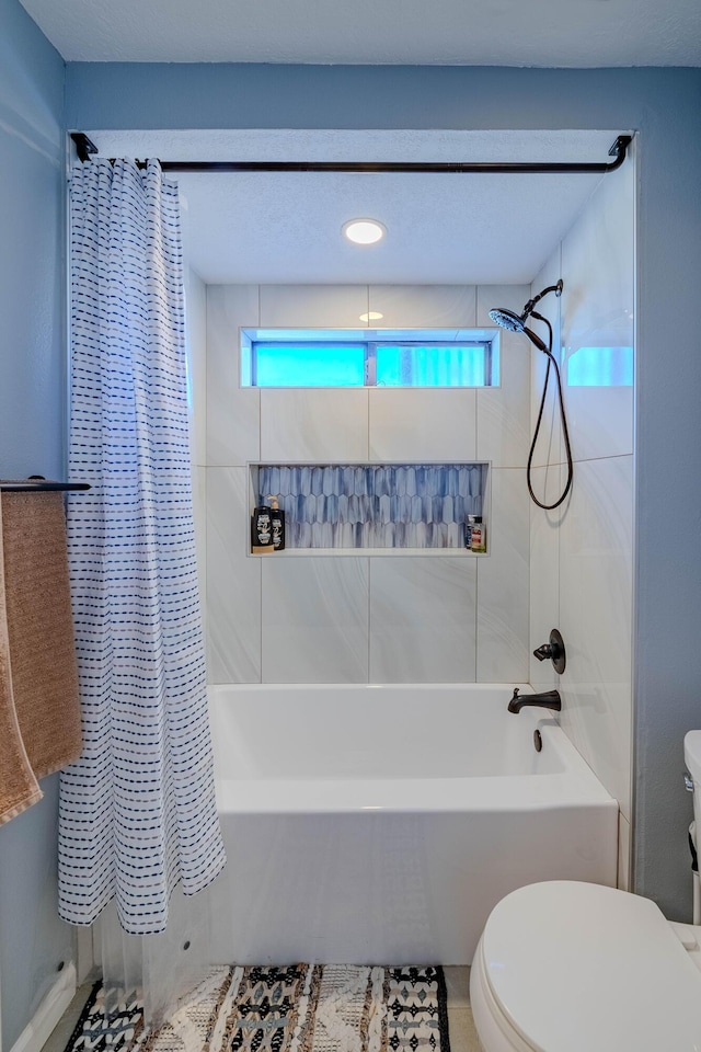 full bath with toilet and shower / tub combo with curtain