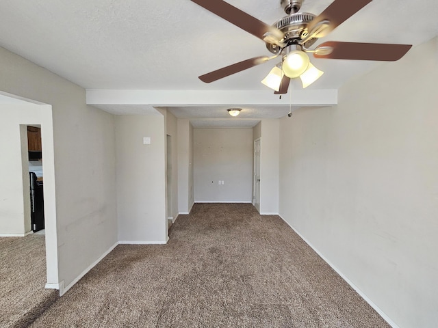 carpeted empty room featuring baseboards and a textured ceiling