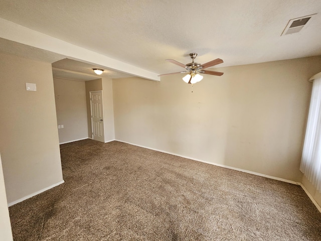 carpeted empty room with visible vents, baseboards, and ceiling fan