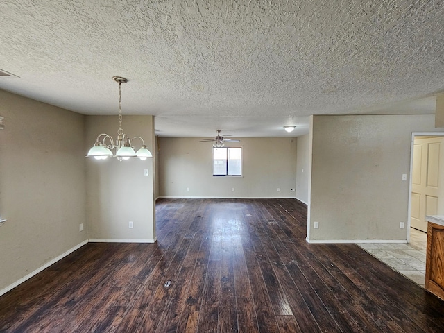 unfurnished room with hardwood / wood-style flooring, ceiling fan with notable chandelier, baseboards, and a textured ceiling