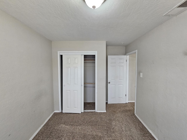 unfurnished bedroom with visible vents, baseboards, a closet, and carpet flooring