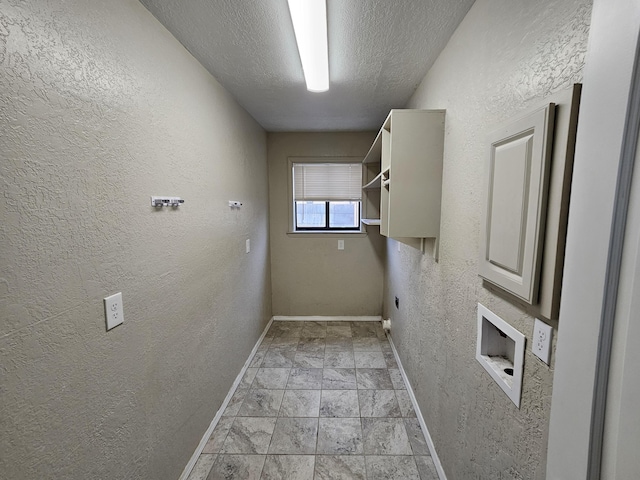 washroom featuring washer hookup, a textured ceiling, baseboards, laundry area, and a textured wall