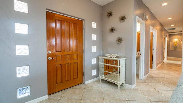 foyer featuring light tile patterned floors, baseboards, visible vents, and recessed lighting