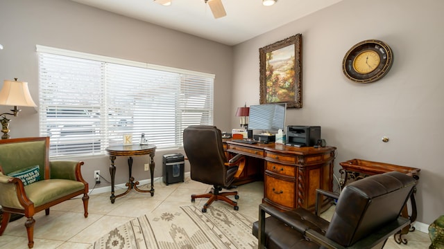 home office with light tile patterned floors, a ceiling fan, and baseboards