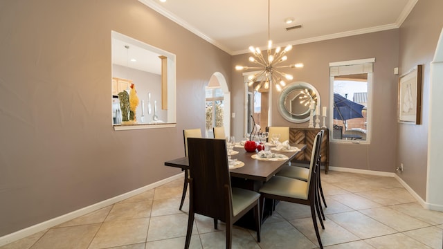 dining area with arched walkways, visible vents, ornamental molding, a chandelier, and baseboards