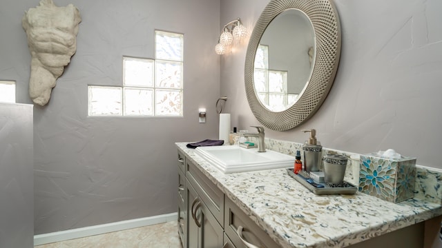 bathroom featuring baseboards and vanity