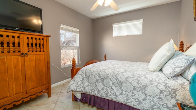 bedroom featuring light tile patterned flooring, a ceiling fan, and baseboards