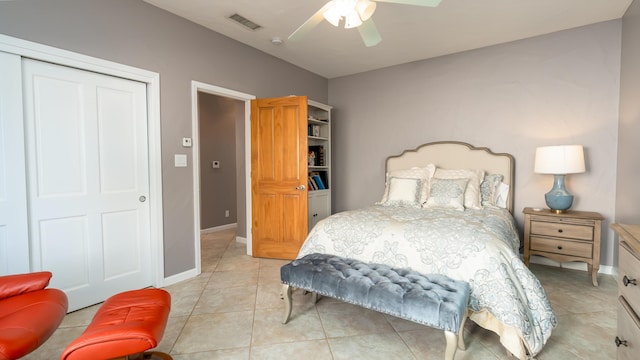 bedroom with light tile patterned floors, ceiling fan, visible vents, baseboards, and a closet