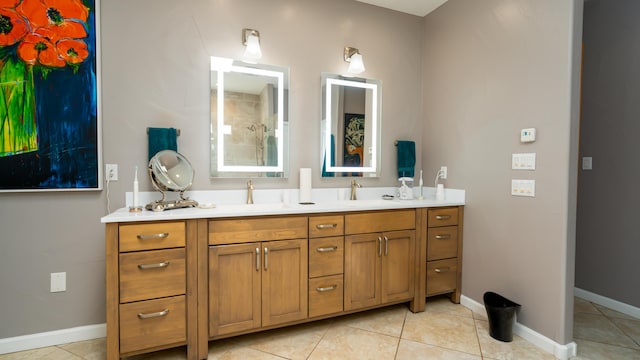 full bath featuring double vanity, tile patterned flooring, baseboards, and a sink