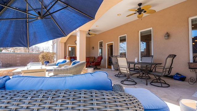 view of patio with a ceiling fan, outdoor dining space, and an outdoor living space