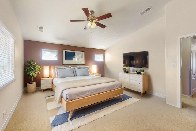 bedroom with light colored carpet, visible vents, and multiple windows