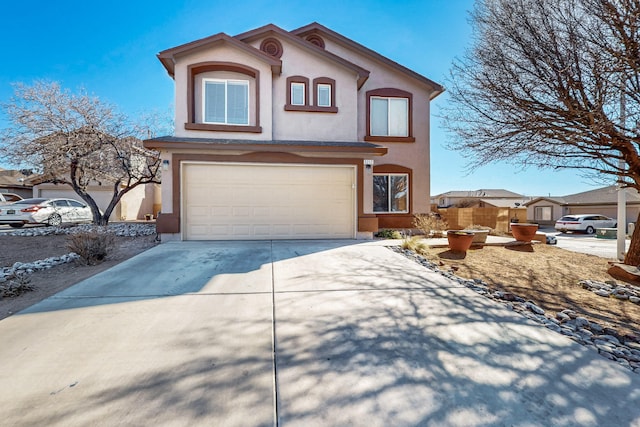 view of front of house with a garage, fence, concrete driveway, and stucco siding