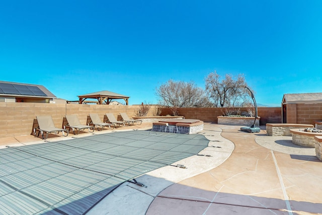 view of swimming pool featuring a patio area, a fenced backyard, a fenced in pool, and a gazebo