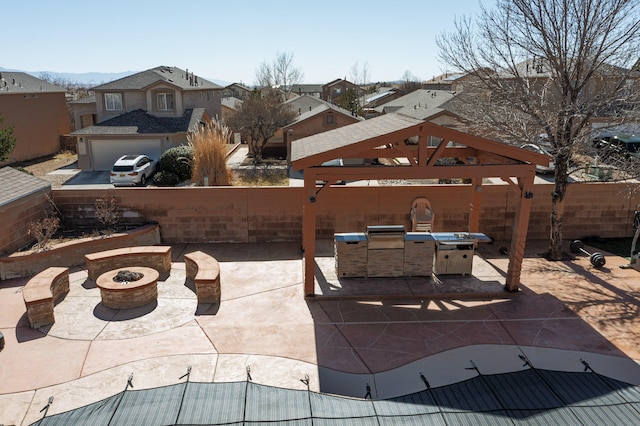 view of patio / terrace featuring a fenced backyard, a residential view, and a fire pit