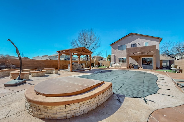 view of swimming pool with an outdoor fire pit, a fenced backyard, a gazebo, a fenced in pool, and a patio area