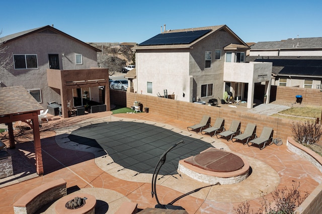 view of swimming pool with an outdoor fire pit, a fenced backyard, and a patio