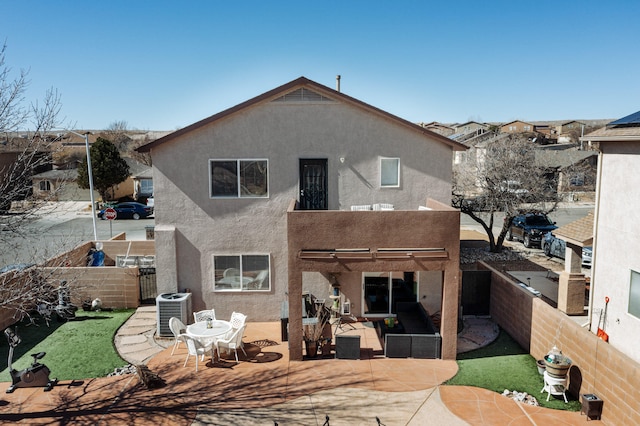 back of house featuring a patio area, a fenced backyard, and stucco siding