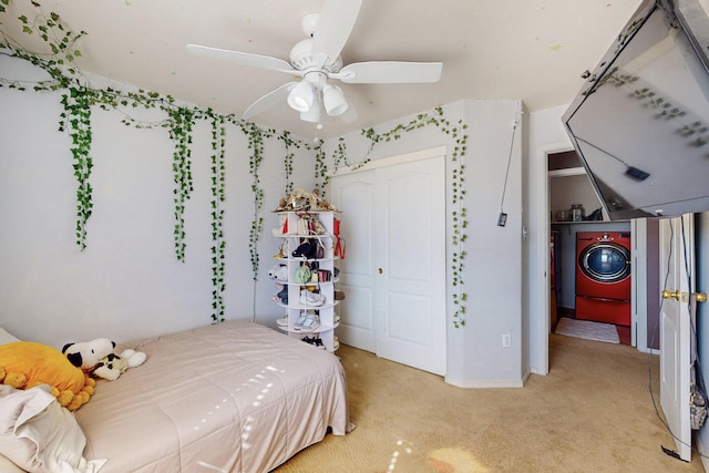 bedroom featuring washer / dryer, ceiling fan, a closet, and light colored carpet