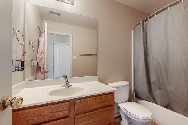 bathroom with shower / bath combo, visible vents, vanity, and toilet