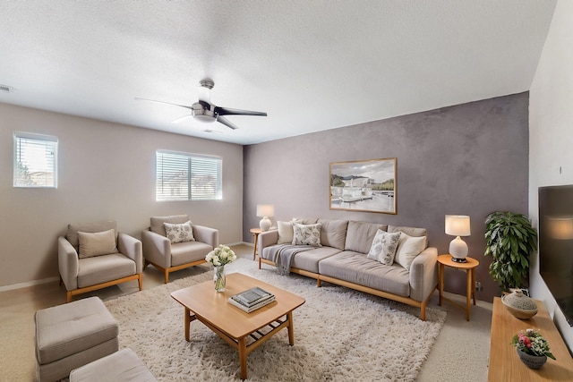 carpeted living area featuring a wealth of natural light, visible vents, and baseboards