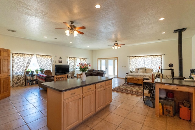 kitchen featuring open floor plan, dark countertops, and a wealth of natural light