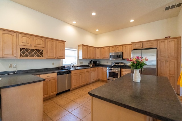 kitchen featuring light tile patterned floors, a sink, visible vents, appliances with stainless steel finishes, and dark countertops