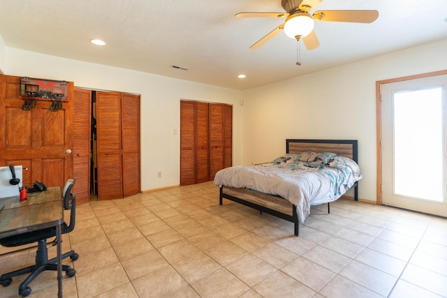 bedroom with a ceiling fan, recessed lighting, visible vents, and multiple closets