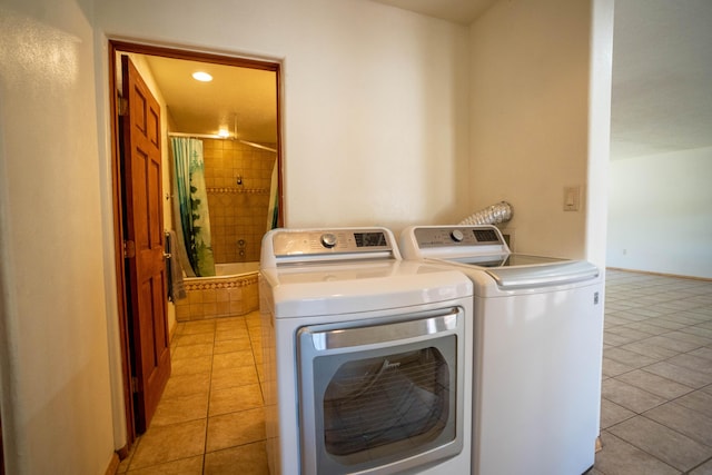 clothes washing area featuring light tile patterned floors, laundry area, baseboards, washer and dryer, and recessed lighting