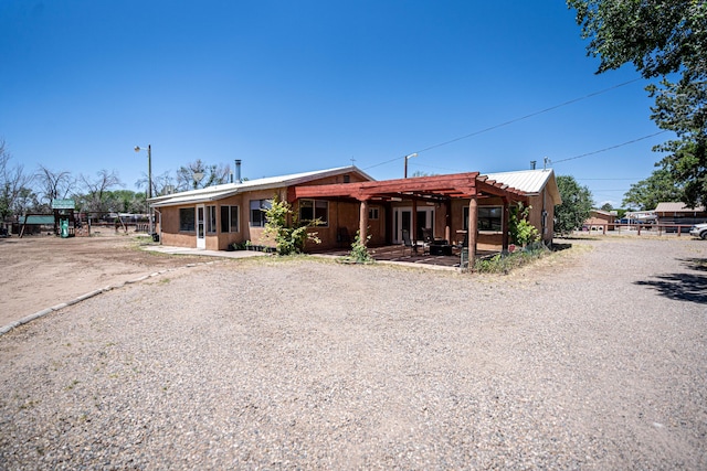 view of front of home with a patio area and a pergola