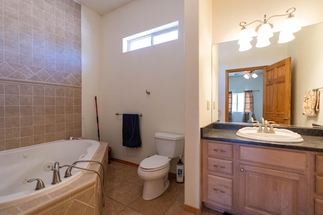 full bath with toilet, vanity, tile patterned flooring, baseboards, and a tub with jets